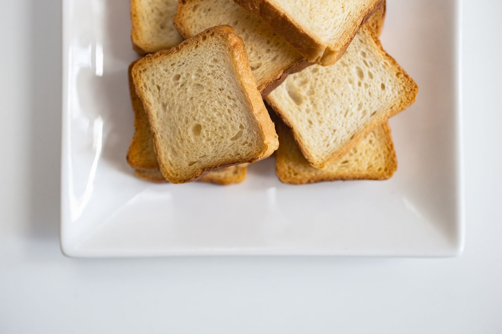 Slices of plain toast on a white plate